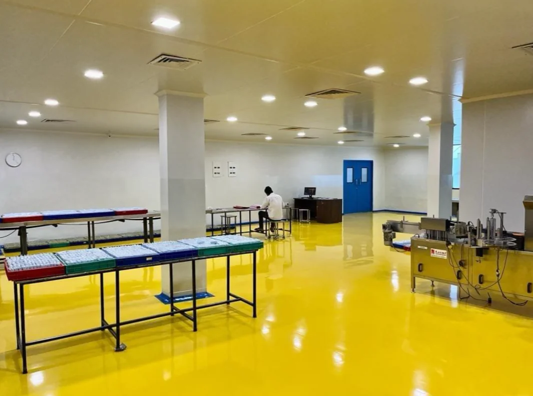 Completed cleanroom installation with yellow flooring, worktables and equipment