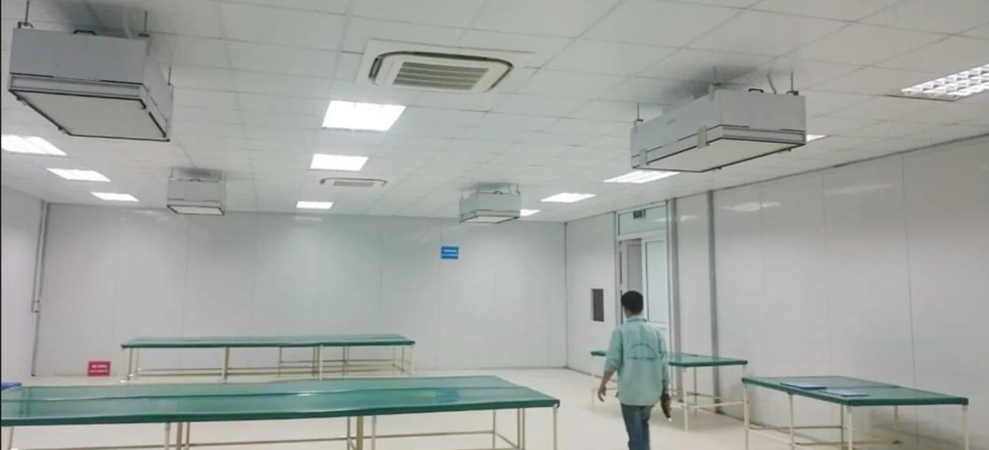 Controlled production room with cleanroom worktables and ceiling air units