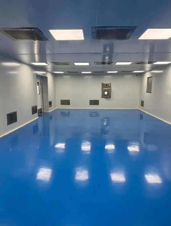 Completed cleanroom interior with blue flooring, modular wall panels and ceiling air outlets