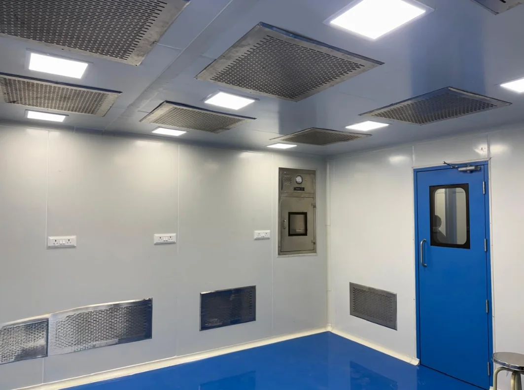 Cleanroom interior with blue door, smooth flooring and ceiling air outlets